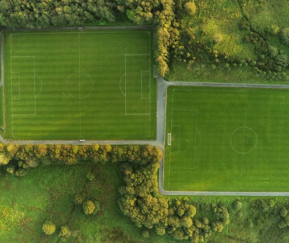 Panorama image of two football training field in a park. Aerial drone view. Soccer pitch view from top. Nobody