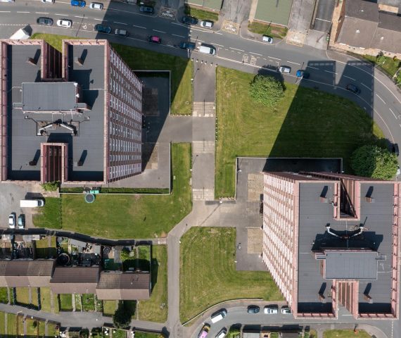 Aerial straight down drone photo of the town of Bramley which is a district in west Leeds, West Yorkshire, England UK, showing residential housing estates and the top apartment blocks in the summer